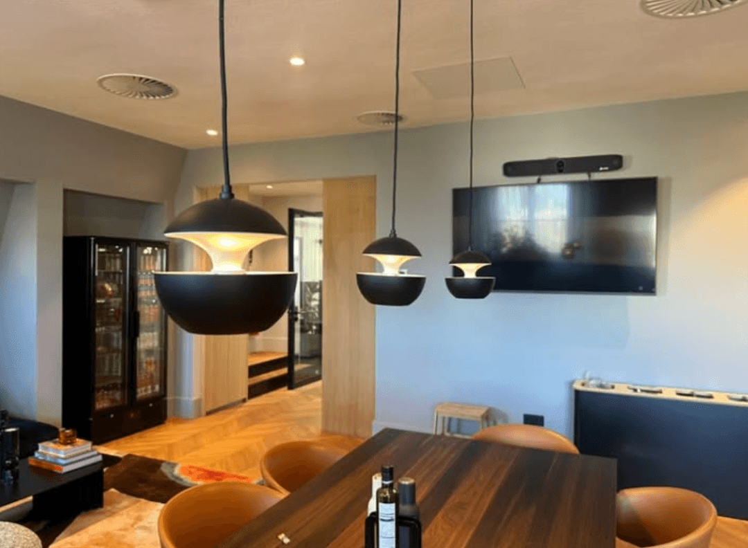 Zwarte hanglampen boven de eettafel in een moderne woonkamer